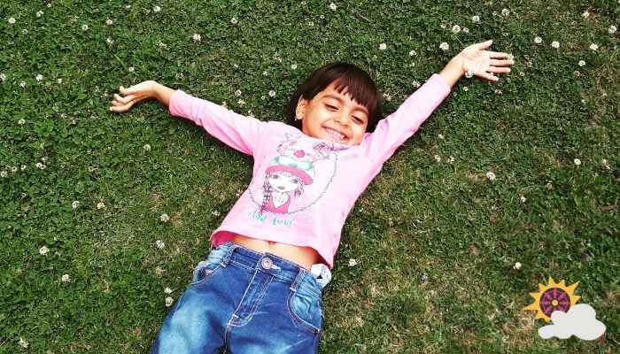 image of happy girl lying in grass